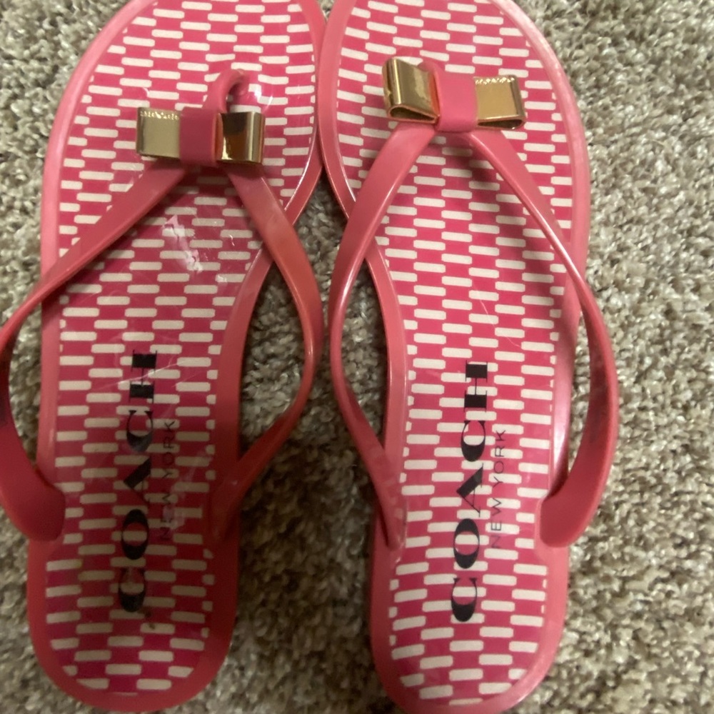 Check out these Coach Flip flops with a gold bow